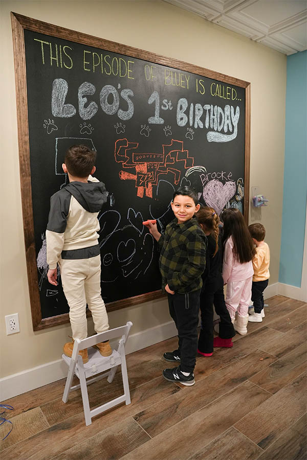 a kids writing on a chalk board